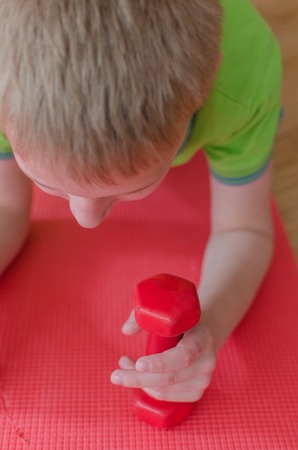 Young boy is making sports exercisesの写真素材
