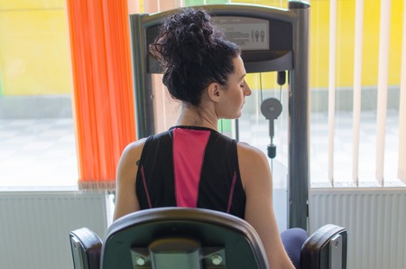 Young woman is training in the gym