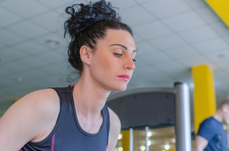 Young woman is training in the gymの写真素材