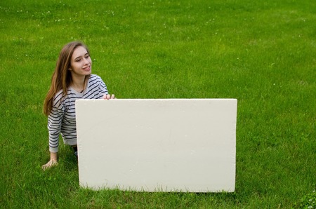 Young girl with the white banner in the cityの写真素材