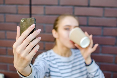 Young girl making selfie with her cell phoneの写真素材