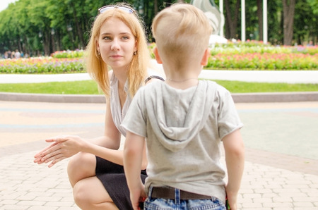 Small baby bo is having fun in the park with his motherの写真素材