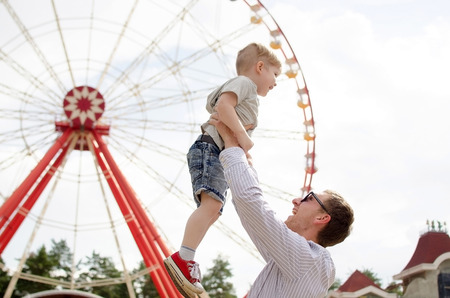 Small baby boy is having fun with his father in the parkの写真素材