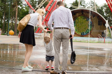 Young family is walking in the park during the summerの写真素材
