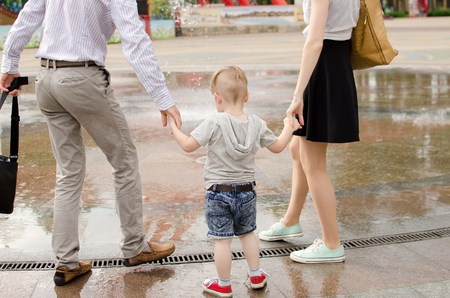 Young family is walking in the park during the summerの写真素材