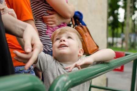Small baby boy is enjoing his time in the park