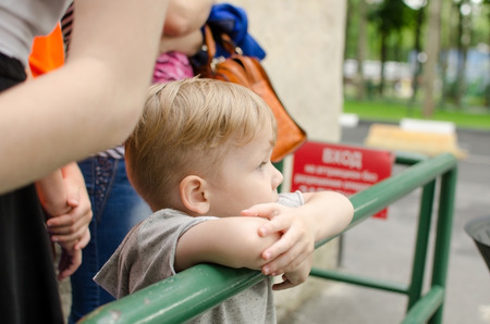 Small baby boy is enjoing his time in the park