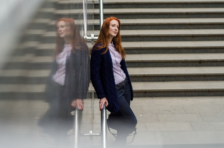 Young red woman walking and resting in the cityの写真素材