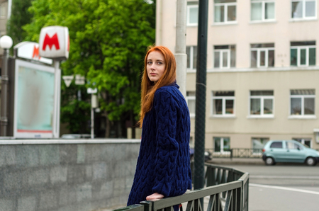 Young red woman walking and resting in the cityの写真素材