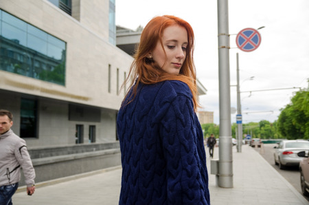 Young red woman walking and resting in the cityの写真素材