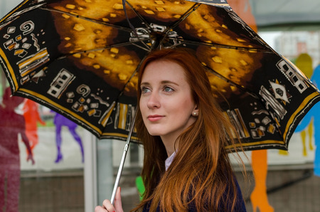 Young red woman walking and resting in the cityの写真素材