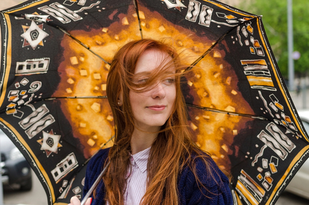 Young red woman walking and resting in the cityの写真素材