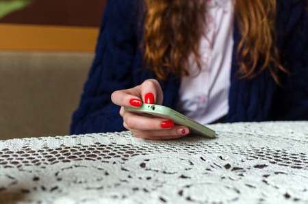 Young red woman using her cell phoneの写真素材