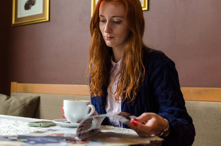 Young red woman using her cell phoneの写真素材