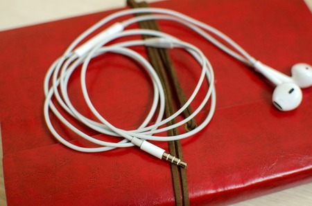 Set of daily planner and headphones on the wooden table