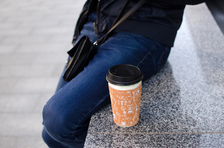 Young man using his phone on the streetの写真素材