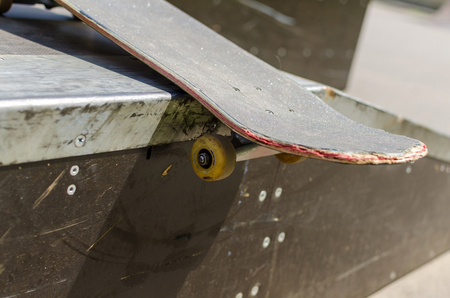Young man with skateboard in the parkの写真素材