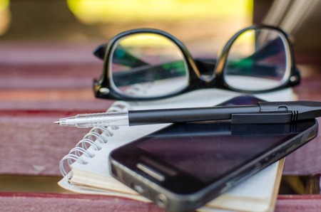 Closeup of cellphone with the glassesの写真素材