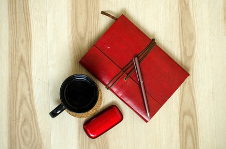 Set of cup, red daily planner and old cellphoneの写真素材