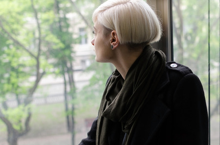Young blonde girl walking on the city streets