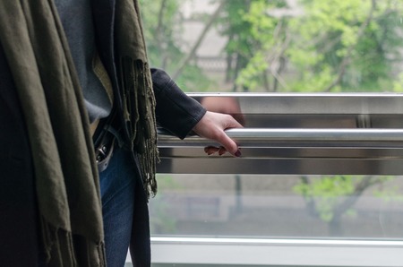 Young blonde woman with a short hair uses elevator