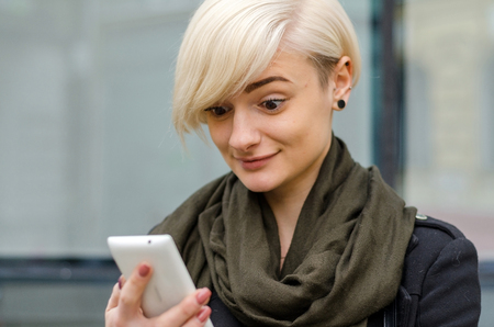Young girl using her phone in the cityの写真素材