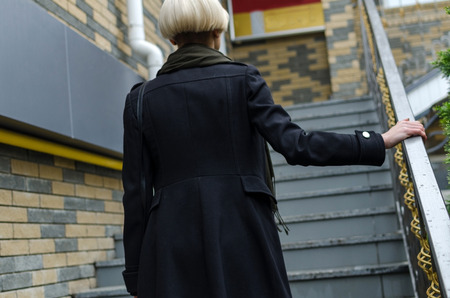 Young girl going up the stairs on the street stepsの写真素材