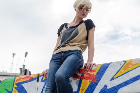 Young blonde girl walking on the city streetsの写真素材
