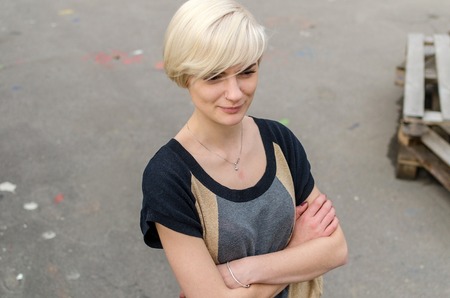 Young blonde girl walking on the city streetsの写真素材