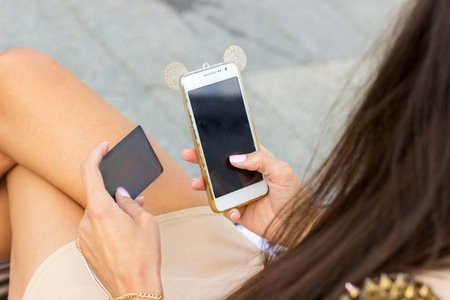 Young woman using credit card on the benchの写真素材