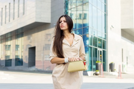 Young woman is walking on the city streetsの写真素材