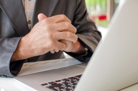 Aged man is using laptop in the parkの写真素材