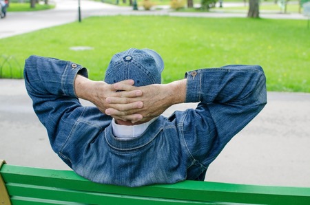 Aged man is resting in the parkの写真素材
