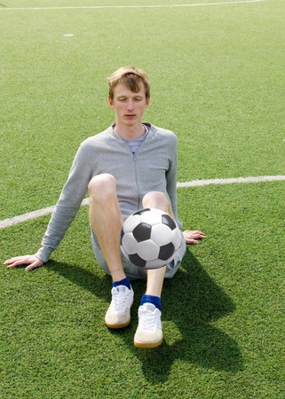 Young man making football freestyle on the football fieldの写真素材