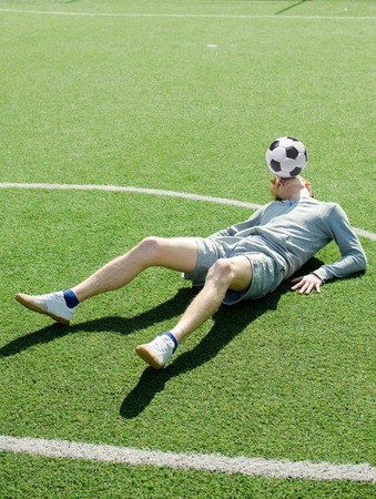 Young man making football freestyle on the fieldの写真素材