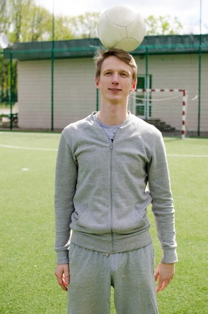 Young man making football freestyle on the fieldの写真素材