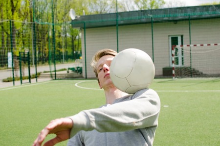 Young man making football freestyle on the fieldの写真素材