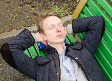 Young man relaxing in the park during the summer timeの写真素材