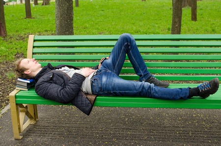 Young man relaxing in the park during the summer timeの写真素材