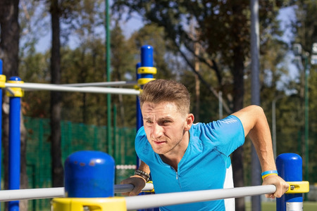 Young sportsman making exersises in the parkの写真素材
