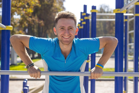 Young sportsman making exersises in the park