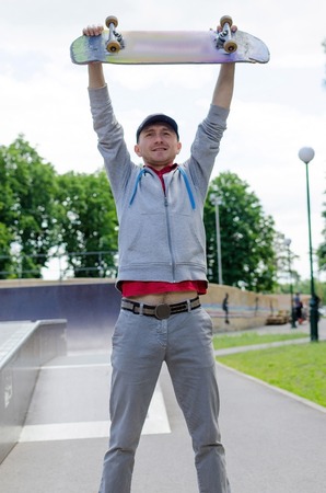 Young man with skateboard in the parkの写真素材