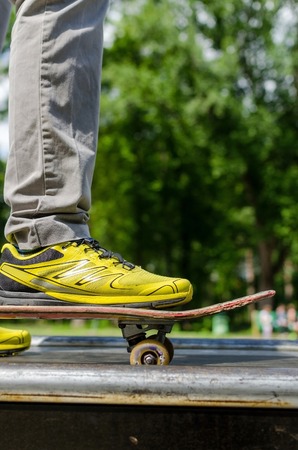 Young man with skateboard in the parkの写真素材