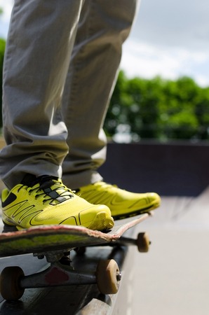 Young man with skateboard in the parkの写真素材
