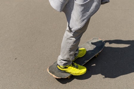 Young man with skateboard in the parkの写真素材