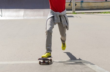 Young man with skateboard in the parkの写真素材