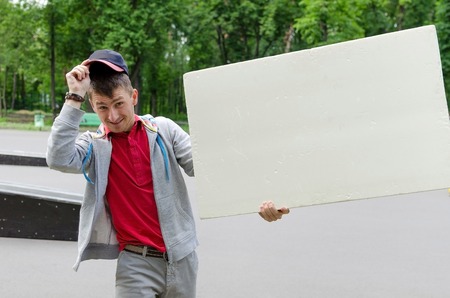 Man with white billboard in park 
natureの写真素材