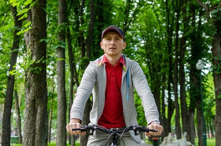 Young man with the bicycle in the park