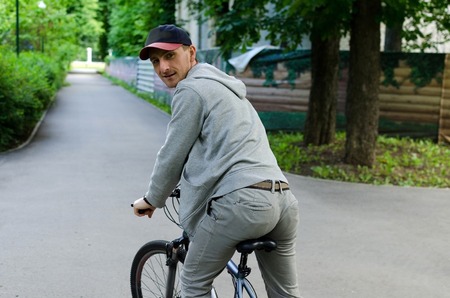 Young man with the bicycle in the park