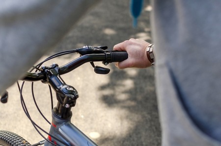 Young man with the bicycle in the park
